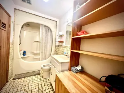 a small bathroom with a toilet and a sink at Cozy and spacious room near UBC-2 in Vancouver