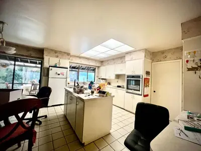 a kitchen with white appliances and a table and chairs at Comfortable private room near UBC-B in Vancouver