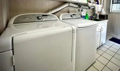 a white washer and dryer in a kitchen at Comfortable private room near UBC-B in Vancouver