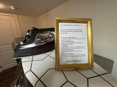 a sign sitting on a kitchen counter with a telephone at Luxurious Air Conditioned Inner City Bungalow in Calgary