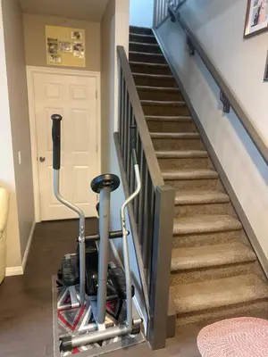 an exercise bike parked next to a stairway at Spacious Bedroom-Near Airport YYC in Airdrie