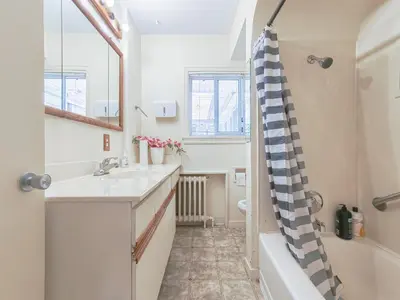 a bathroom with a sink and a tub at Cozy Airb&b Suite in South Vancouver in Vancouver