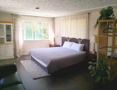 a bedroom with a large bed and a window at Vancouver Richmond Villa39 in Richmond