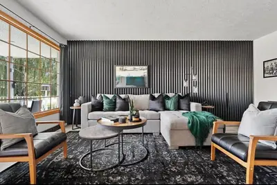 a living room with a couch and a table at The Coal Stone throw away from Red Deer River 2BR House in Drumheller