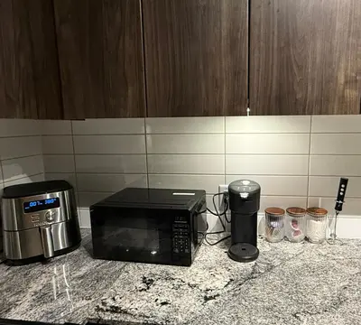 a microwave sitting on top of a kitchen counter at Victoria Colwood Place in Colwood