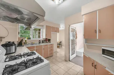 a kitchen with a stove top oven in a room at Cozy Airb&b Guest Suite Near Metrotown in Burnaby
