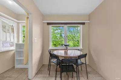 a dining room with a table and chairs and a window at Cozy Airb&b Guest Suite Near Metrotown in Burnaby