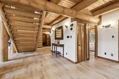 a large living room with wooden ceilings and wooden floors at Nordegg Timber Estate in Nordegg