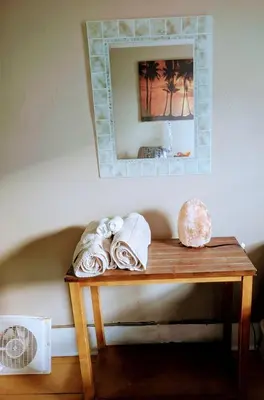 a table with a mirror and towels on it at Tania's guest rooms in Calgary