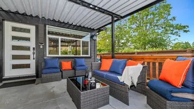 a patio with blue and orange pillows on a deck at Knockan Hill Rentals - Garden Suite in Victoria