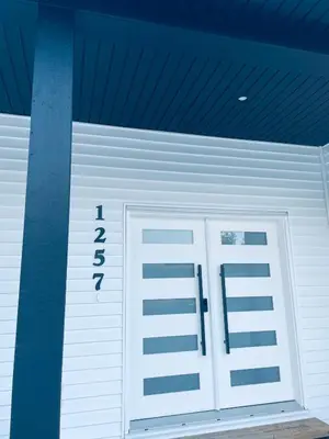 a garage with a white door in a building at Castle BNB 2025 in Gibsons