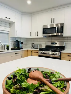 a bowl of salad on a counter in a kitchen at Castle BNB 2025 in Gibsons