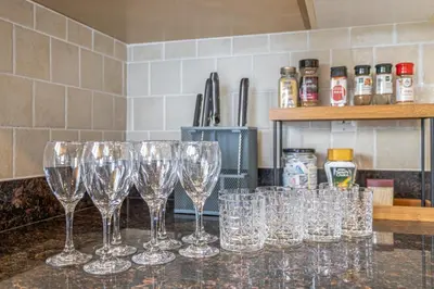 a group of wine glasses sitting on a counter at Central Spacious 3 Br Upstairs in Vancouver