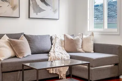 a living room with a couch and a coffee table at Central Spacious 3 Br Upstairs in Vancouver