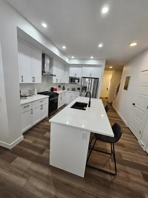 a kitchen with white cabinets and a white counter top at Family Friendly in Calgary