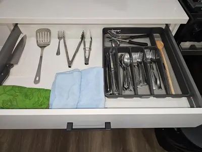 a white drawer filled with utensils and utensils at Family Friendly in Calgary
