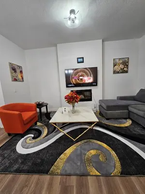 a living room with a couch and a table at Family Friendly in Calgary