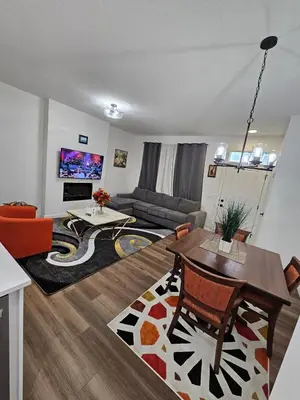 a living room with a couch and a table at Family Friendly in Calgary