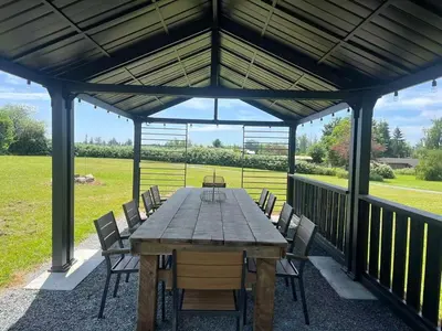 a wooden table and chairs on a patio at Sunshine garden 5 bedrooms2 living rooms3 bathrooms1 kitchen in Aldergrove