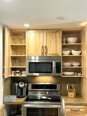 a kitchen with a stove and a microwave at XL Luxury Penthouse Ski-in Ski-out The Aspens in Whistler