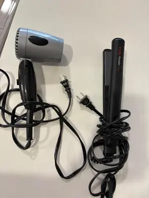 a hair dryer and a blow dryer with a cord at Boho Studio Downtown Rogers Views Heated Parking in Edmonton
