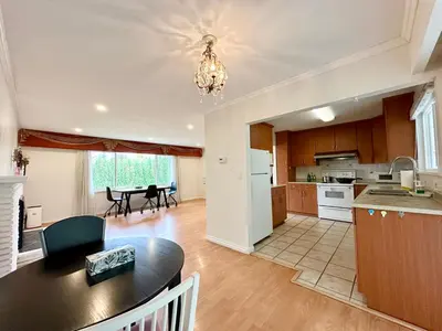 an open kitchen and dining room with a dining table at Cozy 3 Bedrooms with Kitchen and Laundry Near Airport in Richmond