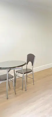 a table and a chair sitting next to a table at Cozy New Suite 8mins to Downtown in Vancouver