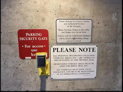 a sign for a parking security gate and a please note at Quiet & Cozy Ski-In Out, Hot tub, pool in Whistler