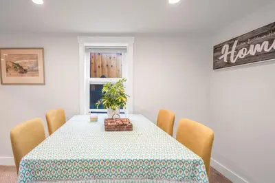a dining room with a table with a plant on it at Prestigious 2 Bedrooms 2 Baths in West Point Grey in Vancouver