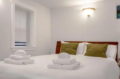 a bedroom with a bed with white towels on it at Prestigious 2 Bedrooms 2 Baths in West Point Grey in Vancouver