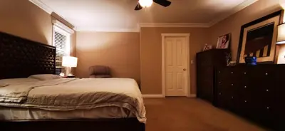a bedroom with a large bed with a dresser and a window at Eagle's House, Room #B in Victoria