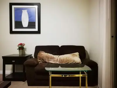 a living room with a couch and a table at Eagle's House, Room #1 in Victoria