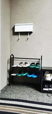 a shelf with shoes on it next to a wall at Eagle's House, Room #2 in Victoria