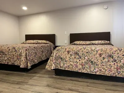two beds sitting next to each other in a room at Kluane Park Inn in Haines Junction