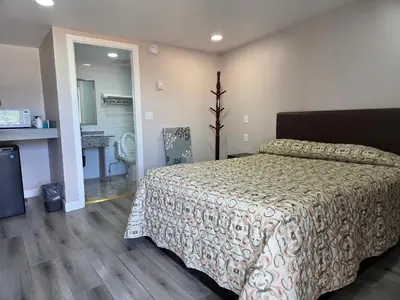 a bedroom with a bed and a bathroom at Kluane Park Inn in Haines Junction