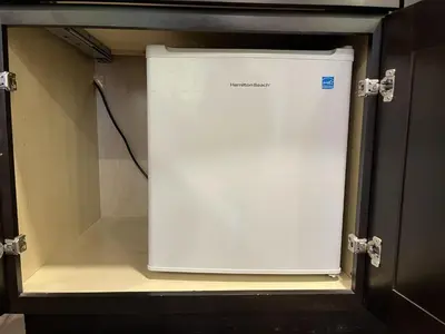 a white refrigerator sitting inside of a room at Kluane Park Inn in Haines Junction
