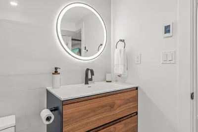 a bathroom with a sink and a mirror at Blue Spruce Den - Vernon in Vernon