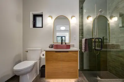 a bathroom with a toilet and a sink and a shower at Fogged Inn in Ucluelet
