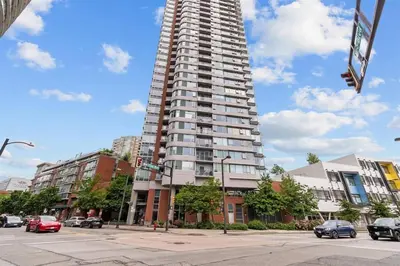 a tall apartment building on a city street with cars at Downtown,FreeParking,Pool,Comfy,OceanMontain View in Vancouver
