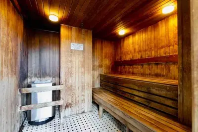 a bathroom with a wooden bench and a toilet at Downtown,FreeParking,Pool,Comfy,OceanMontain View in Vancouver