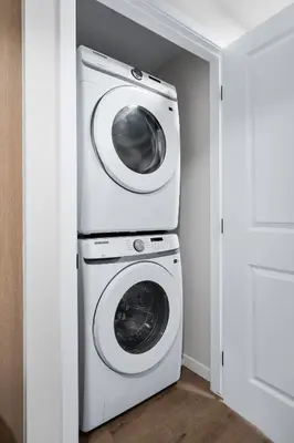 a laundry room with a washer and dryer at Cozy 2BR Suite with Kitchen, AC Near U of C, Winsport, Banff and Hospitals in Calgary