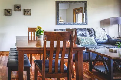 a living room with a table and a couch at Creekside at Rundle Cliffs Lodge in Canmore