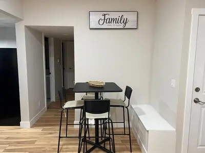 a dining room with a table and chairs at Little Heaven 2BR southwest Calgary in Calgary