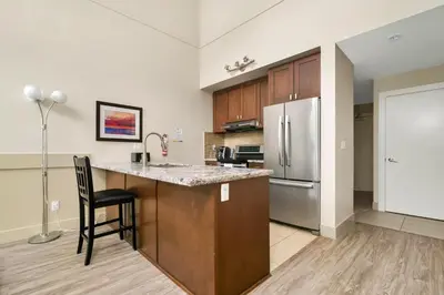 a kitchen with a counter and a refrigerator at Harrison 3BR Pet friendly Unit in Harrison Hot Springs