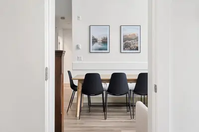 a dining room with a table and black chairs at 4BR Unit In The Heart Of Harrison in Harrison Hot Springs