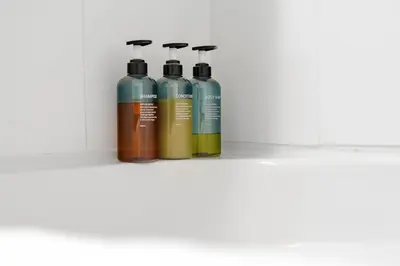 a group of three bottles sitting on a shelf at 2BR Suite with Scenic Views in Harrison Hot Springs