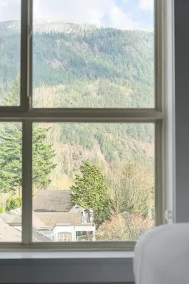 a window view of a mountain view from a house at 2BR Suite with Scenic Views in Harrison Hot Springs