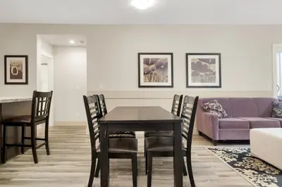 a living room with a table and a purple couch at 2BR Suite with Scenic Views in Harrison Hot Springs