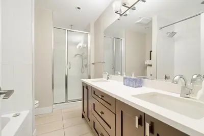 a bathroom with a sink and a large mirror at Serenity Luxe 2BR unit in Harrison in Harrison Hot Springs