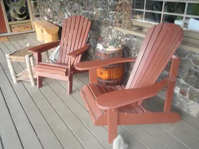 two rocking chairs and a barrel on a porch at Mountain Springs Nature Retreat in Kaleden